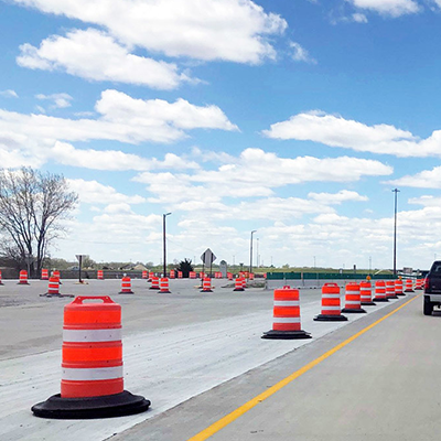 Shows a wide angle of traffic barrel tire ring in use on the road.