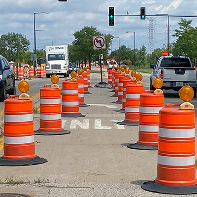 Shows a close up angle of traffic barrel tire ring in use on the road.