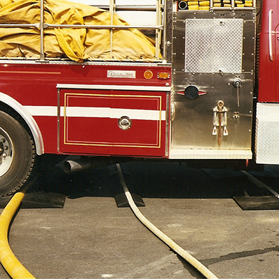 Hose ramp shown protecting hose from passing fire truck.