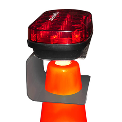 3 Foxfire safety cone brackets in use on traffic cones at night.