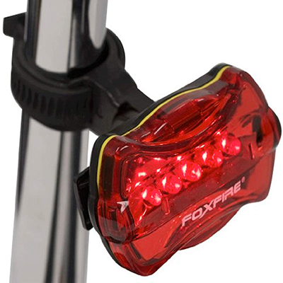 Foxfire personal led red safety light shown up close mounted on a pole.