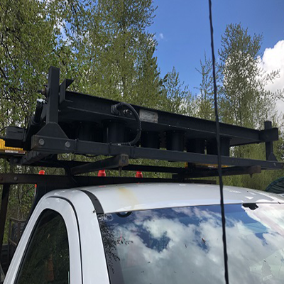 In use: 36" x 72" arrow board with amber LEDs installed on the cab of a white truck.