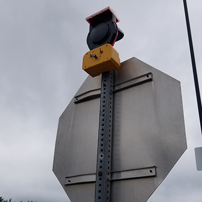 Type B Hooded Solar Barricade Light Mounted View On Back Of Stop Sign Square Post