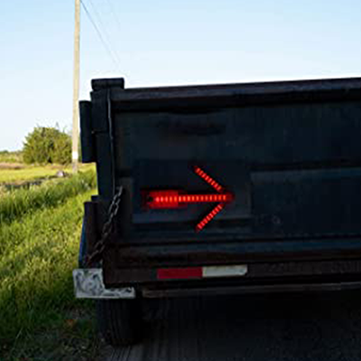 Magnetic traffic warning arrow light affixed to back of truck.